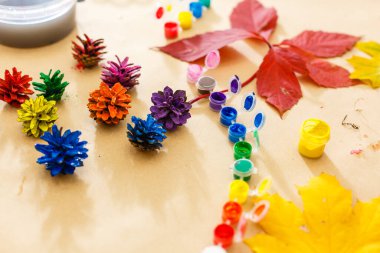 Yaprak ve konileri boyamak için boya. Yaratıcılıkla ilgili sonbahar geçmişi, okula dönüş. Okula dönmek için yer ayır.