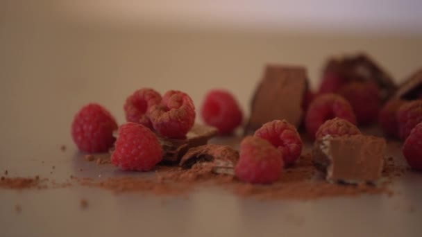 Raspberries and chocolate on the table at home — Stock Video