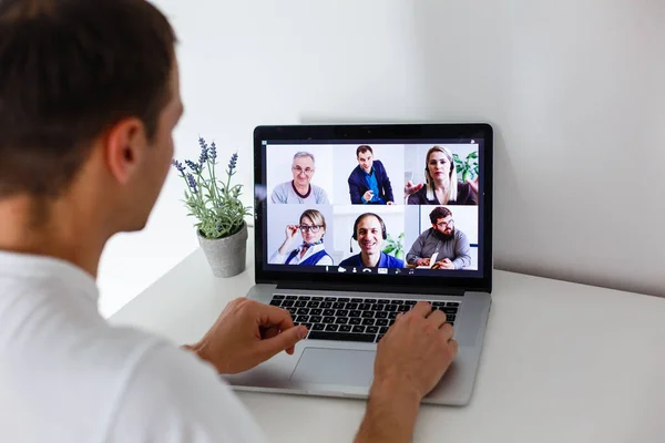 Person Using Video Conferencing technology in kitchen for video call with colleagues at home and in offices