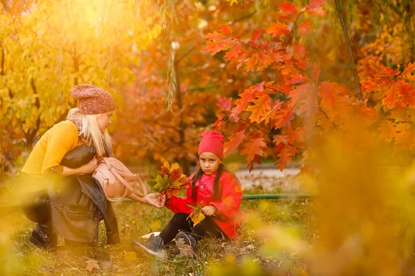 Parent take child to school. Pupil of primary school with backpack outdoors. Mother and daughter go hand in hand. Back to school. First day of fall. Elementary student. Kindergarten, preschool.