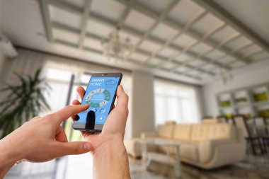 Akıllı ev, ev otomasyonu, uygulama simgeli aygıt. Adam akıllı telefonunu akıllı güvenlik uygulaması ile evinin kapısını açmak için kullanıyor..