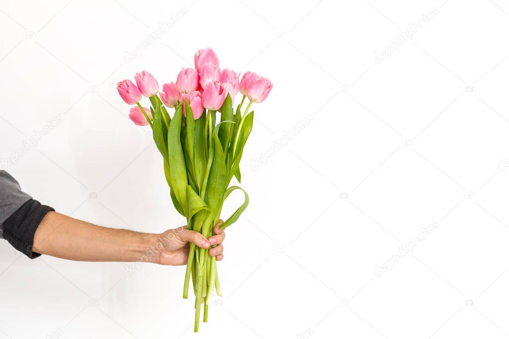 Man with flowers. Romantic Man with bouquet of tulips for birthday. Happy woman's day. Giving bouquet of flowers. Handsome man giving flowers. White background. Horizontal photo.s