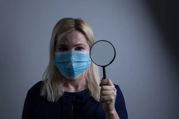 an attractive young woman wears a paper face mask to protect herself from the H1N1 Virus, isolated on white, with room for your text