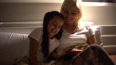 Genç bir anne, kızına kitap, İncil okur. Evdeki kanepede oturur ve kendini izole eder..