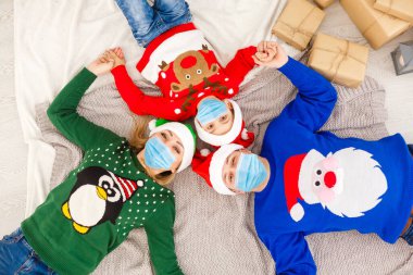 Koruyucu maskeli aile karantinaya alındı. Koronavirüslü normal bir hayat. Yaşam tarzı COVID-19. Karantina Virüsü Koruma Noeli