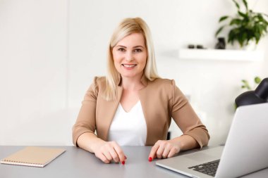 Evde dizüstü bilgisayarla çalışan bir kadın.