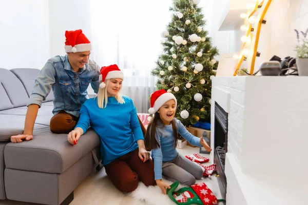家でクリスマスを祝う幸せな若い家族 — ストック写真