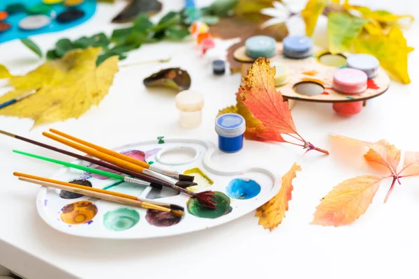 少女は家に筆で葉を描き秋の芸術 — ストック写真