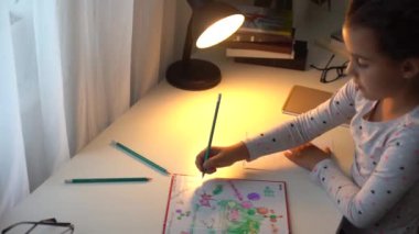 Akıllı ilkokul çocuğu matematik ödevi yapmayı öğreniyor. Evde oturuyor, sevimli, küçük bir anaokulu çocuğu tek başına çalışıyor. Notlar alıyor, ilköğretim konsepti geliştiriyor.
