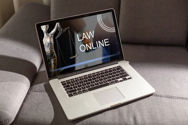 Law icon with modern laptop computer on wooden table over office, Business legal service online concept