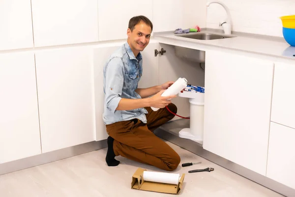 Plumber installs a water filter. water filter.