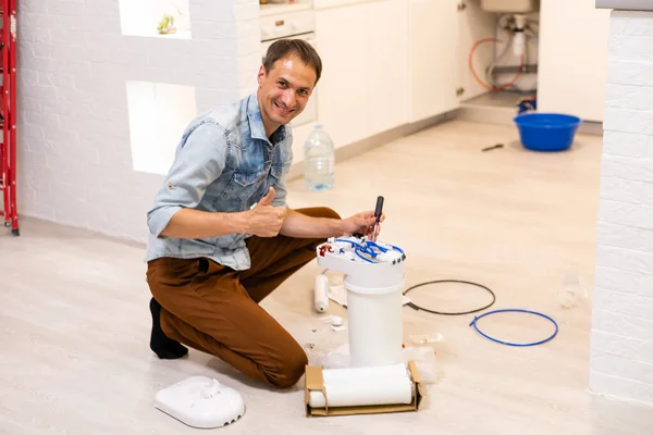 Plumber installs a water filter. water filter.