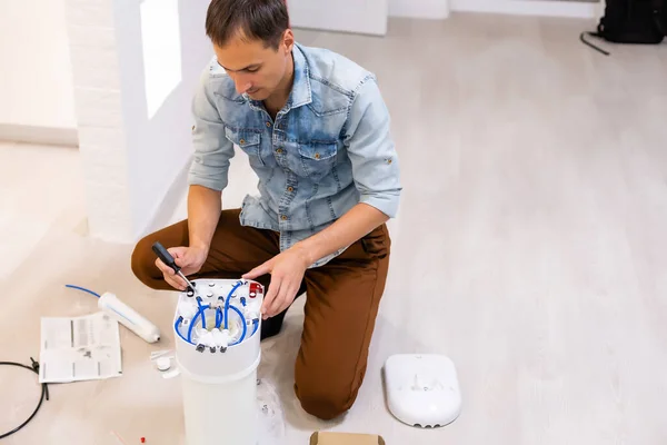 Plumber installs a water filter. water filter.