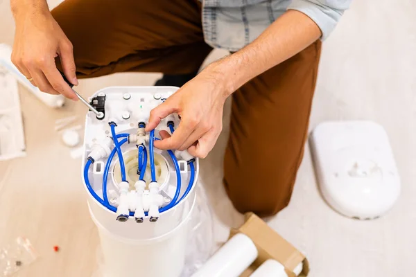 Plumber installs a water filter. water filter.