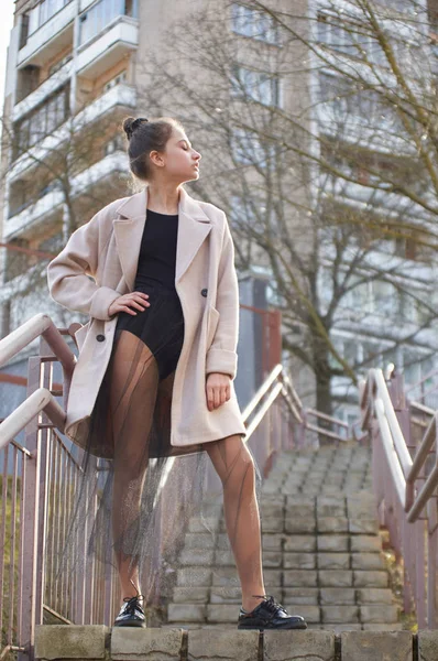 Dancer posing in a city on a stairway in a black leotard. — Stock Photo, Image