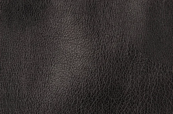 自然な黒い革背景のクローズ アップ — ストック写真