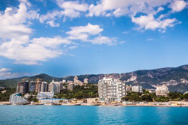 Muhteşem resort şehir ve güneşli güzel mavi deniz üzerinde parlak bulutlu gökyüzü