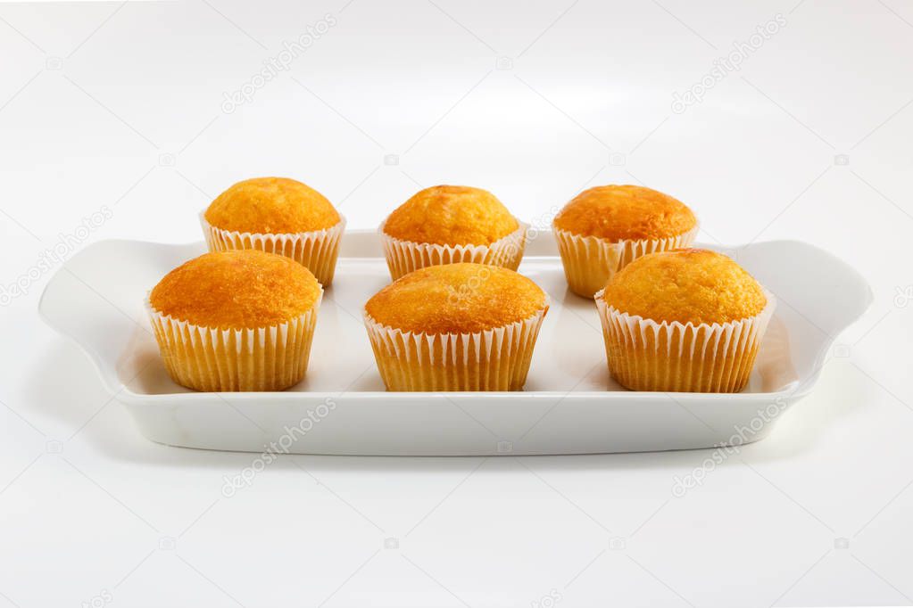 Cupcakes on a white plate on a light background