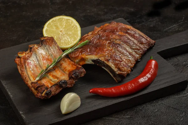 Baked pork ribs with lemon and hot pepper and garlic