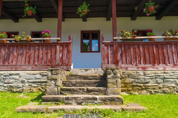 old romanian architecture design closeup: stone stairs, wood railing and roof structur