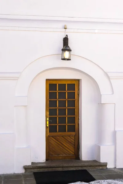 wood door entrance with big simple wall arcade