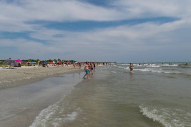 Corbu, Constanta, Romanya - 14 Ağustos 2019: İnsanlar Romanya 'nın Corbu kentindeki son bakir plajda rahatlatıcı bir yaz gününün tadını çıkarıyor