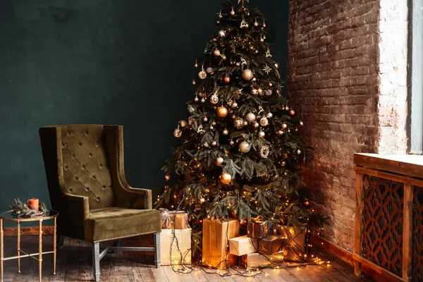 Yeni yıl arka plan. Noel odası iç. Işık, hediyeler, mumlar ve sıcak iç aydınlatma. Hediyeler ile Noel ağacı yakınındaki bir tabloyla bir koltuk