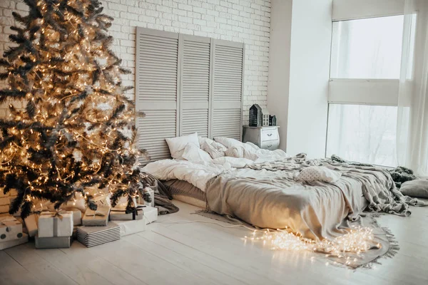 Beautiful light warm interiors of the apartment with New Year\'s decor