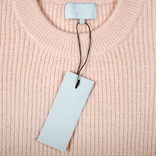 part of knitted peach sweater with blank label