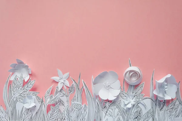 3d white paper flowers with painted leaves and stems on the pink background