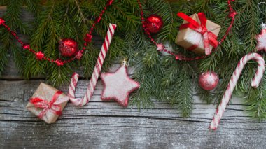 Mutlu Noeller ve mutlu yeni yıl. Dekoratif süslü çam Glitter doğal hediyeler Noel ve tatlılar ahşap arka plan üzerinde. Kırmızı tatil kavramı. Yakın çekim