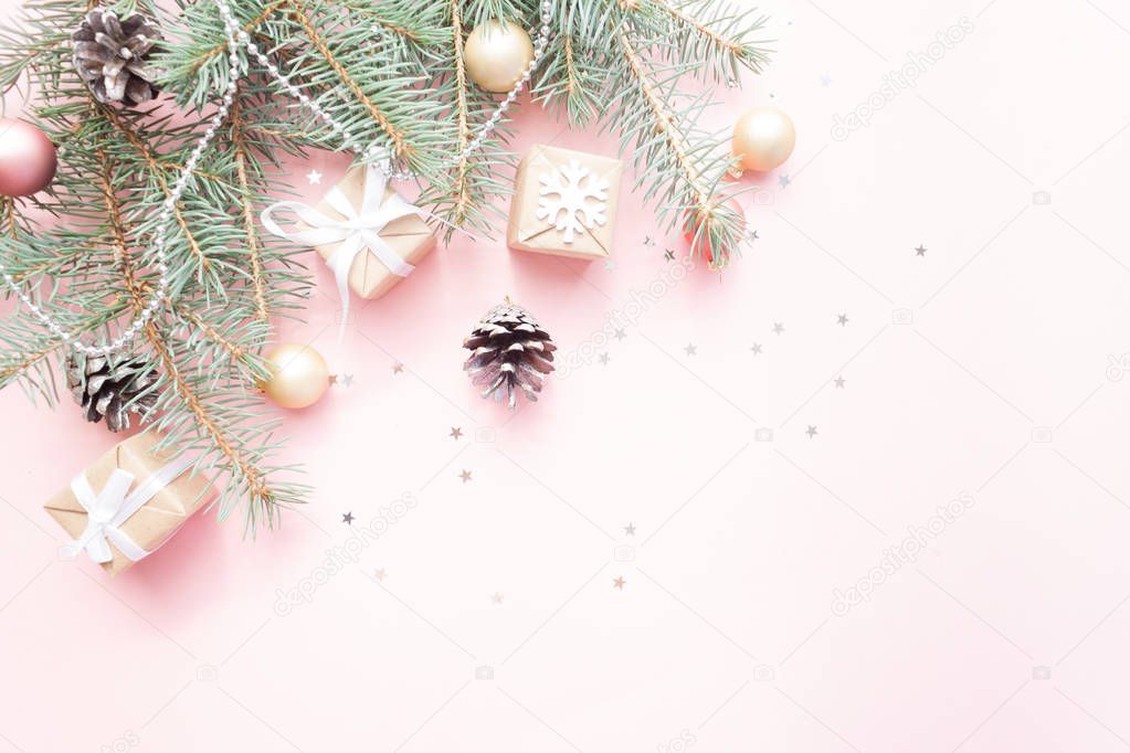 Merry Christmas and Happy New Year. Christmas Card Festive with green Fir Branches and Holiday Object on pale pink Background.