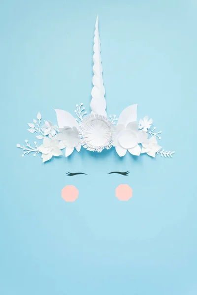 stock image Cute unicorn made of white paper flowers on blue background. Cut from paper