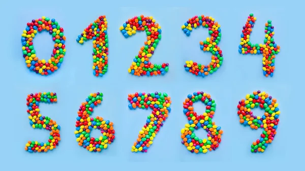 Ψηφία Γίνονται Λίγο Καραμέλες Μπλε Φόντο Σύνολο Των Αριθμών — Φωτογραφία Αρχείου