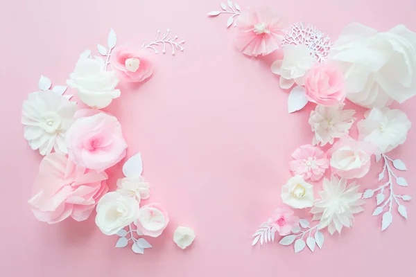 white and pink paper flowers on the pink background. Frame of flower