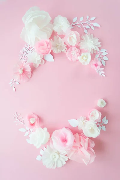 white and pink paper flowers on the pink background. Frame of flower