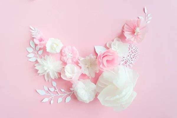 white and pink paper flowers on the pink background. Frame of flower