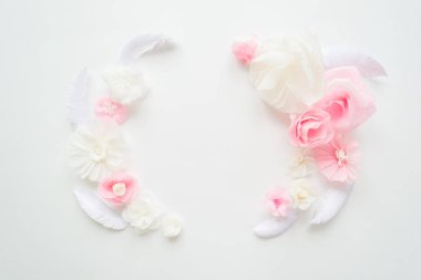 white and pink paper flowers on the white background. Frame of flower