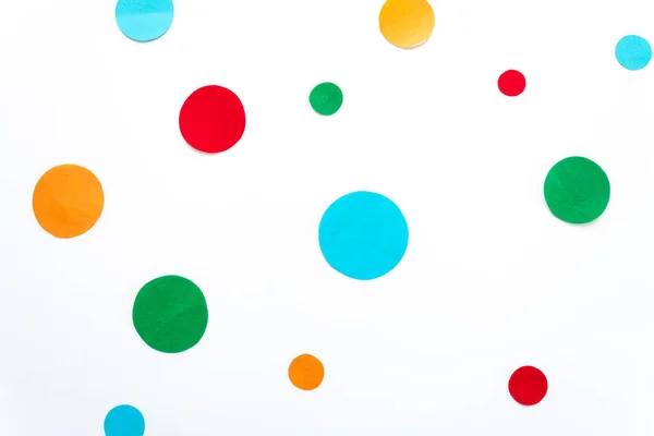 cut out different colored circles on a white background