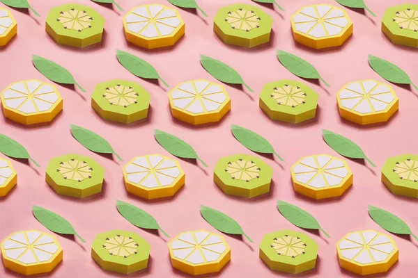 Pattern of fruit made of paper. Pink background. There\'s room for writing. Tropics. Flat lay. Kiwi, lemon.. Yellow summer concept