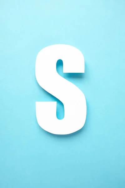 Letter s cut from paper on blue background — Stock Photo, Image