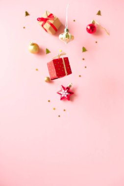 Pembe arka planda farklı noel dekorasyonu ile Şampanya şişesi.