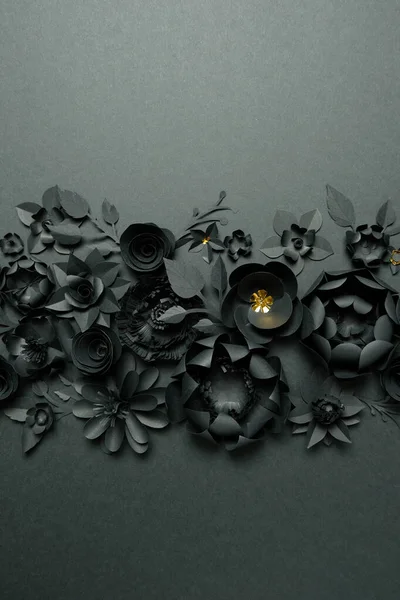 Black paper flowers on Black background. Cut from paper.