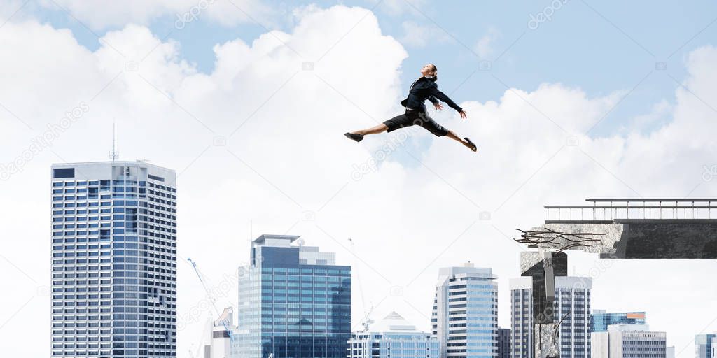 Business woman jumping over huge gap in concrete bridge as symbol of overcoming challenges. Cityscape on background. 3D rendering.