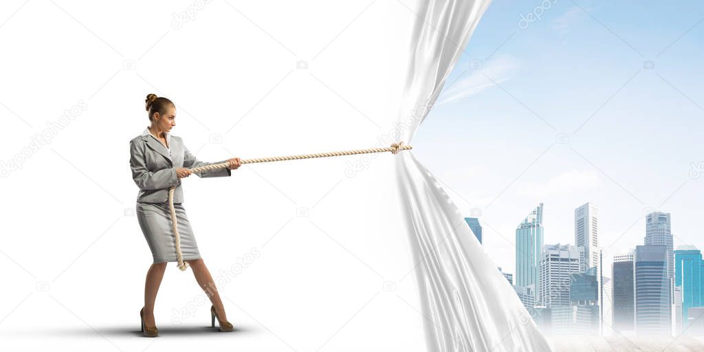 Businesswoman pulling white blank fabric. Place for text