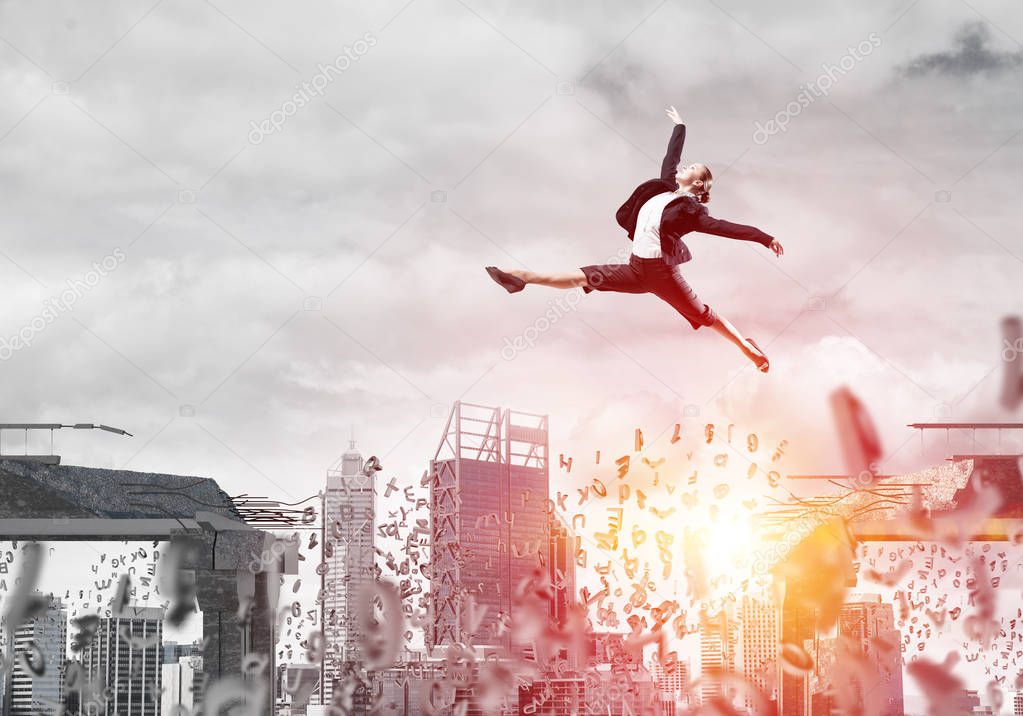 Business woman jumping over gap with flying letters in concrete bridge as symbol of overcoming challenges. Cityscape and sunlight on background. 3D rendering.