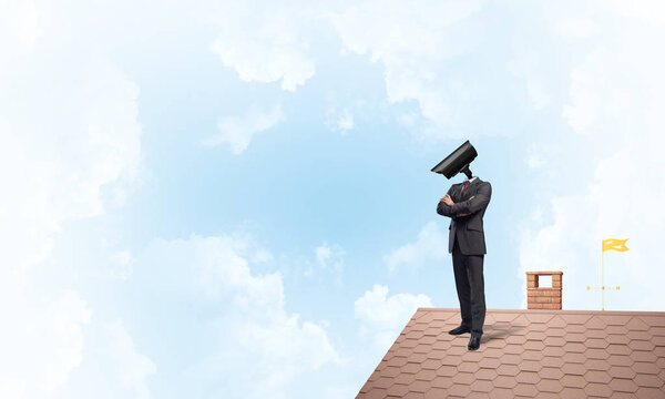 Faceless businessman with camera zoom instead of head standing on house roof