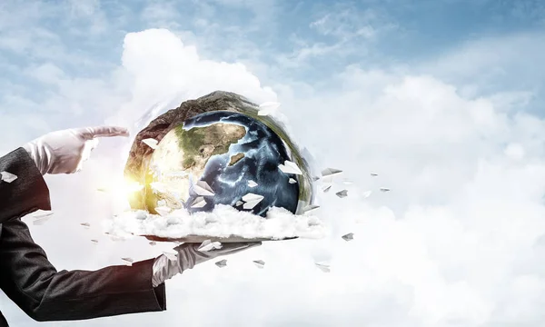 Cropped image of waitress\'s hand in white glove presenting Earth globe on metal tray and pointing on it with cloudy skyscape on background. 3D rendering. Elements of this image are furnished by NASA.
