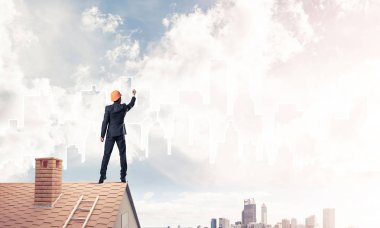 Mühendis, evinin çatısına geri döndü ve şehri çiziyor. Karışık ortam