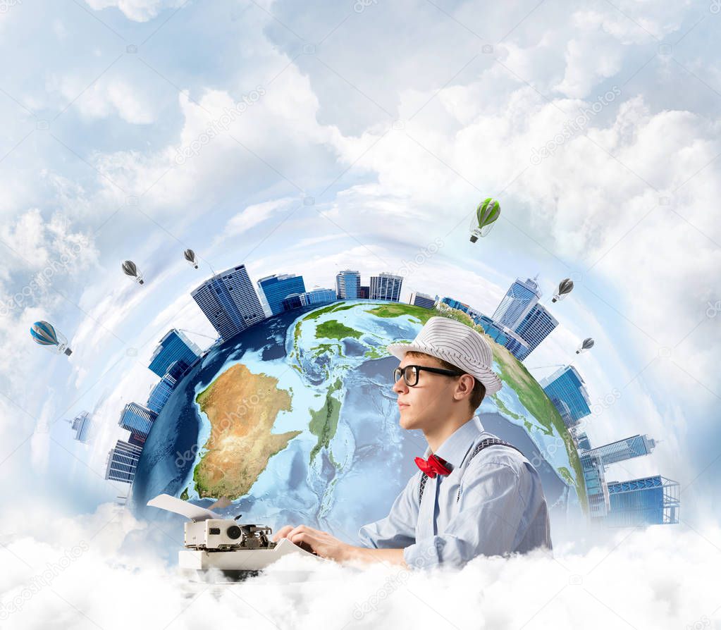 Side view of hard-working man writer using typing machine while sitting at the table with panoramic Earth view and cloudy skyscape on background. Elements of this image furnished by NASA